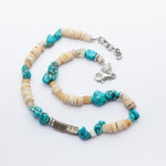 Necklace with turquoise and beige beads on a white background