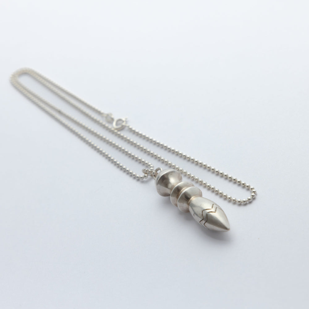 Silver necklace with a unique pendant on a white background