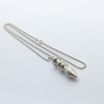 Silver necklace with a unique pendant on a white background